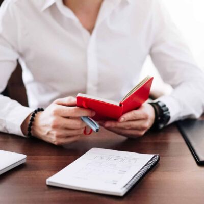 man-reading-notes-from-his-notebook
