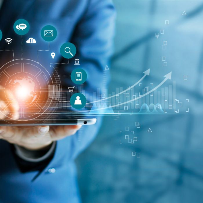 Businessman using tablet analyzing sales data and economic growt