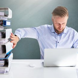 Businessperson Pushing Paper Documents Away And Working With Digital Documents On Computer Instead - archivieren-archivierung